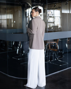 Darian Pants in navy, back view on exterior stairs