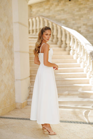 Arlisse Dress in white, seated pose showing comfort