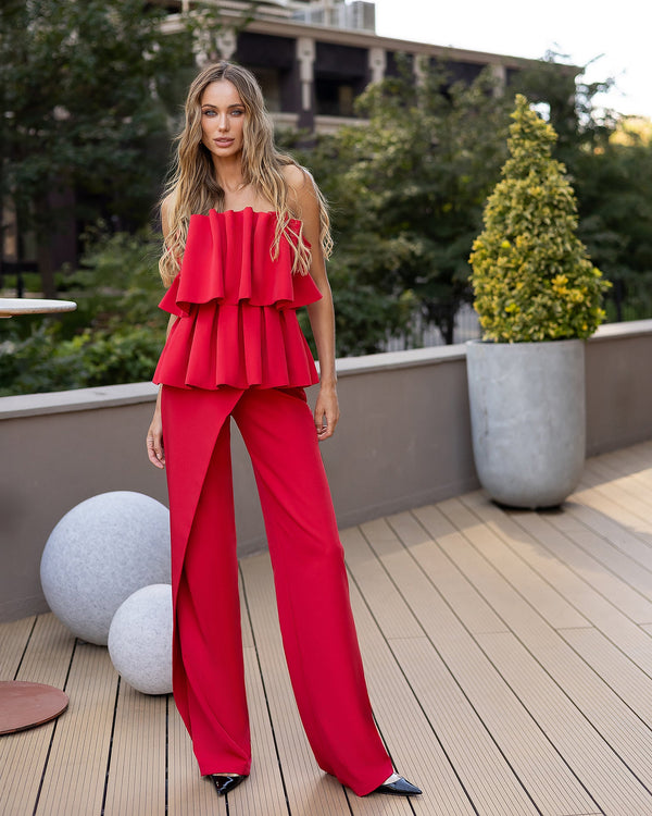Dahlia Pants in red, full-length front view on stairs