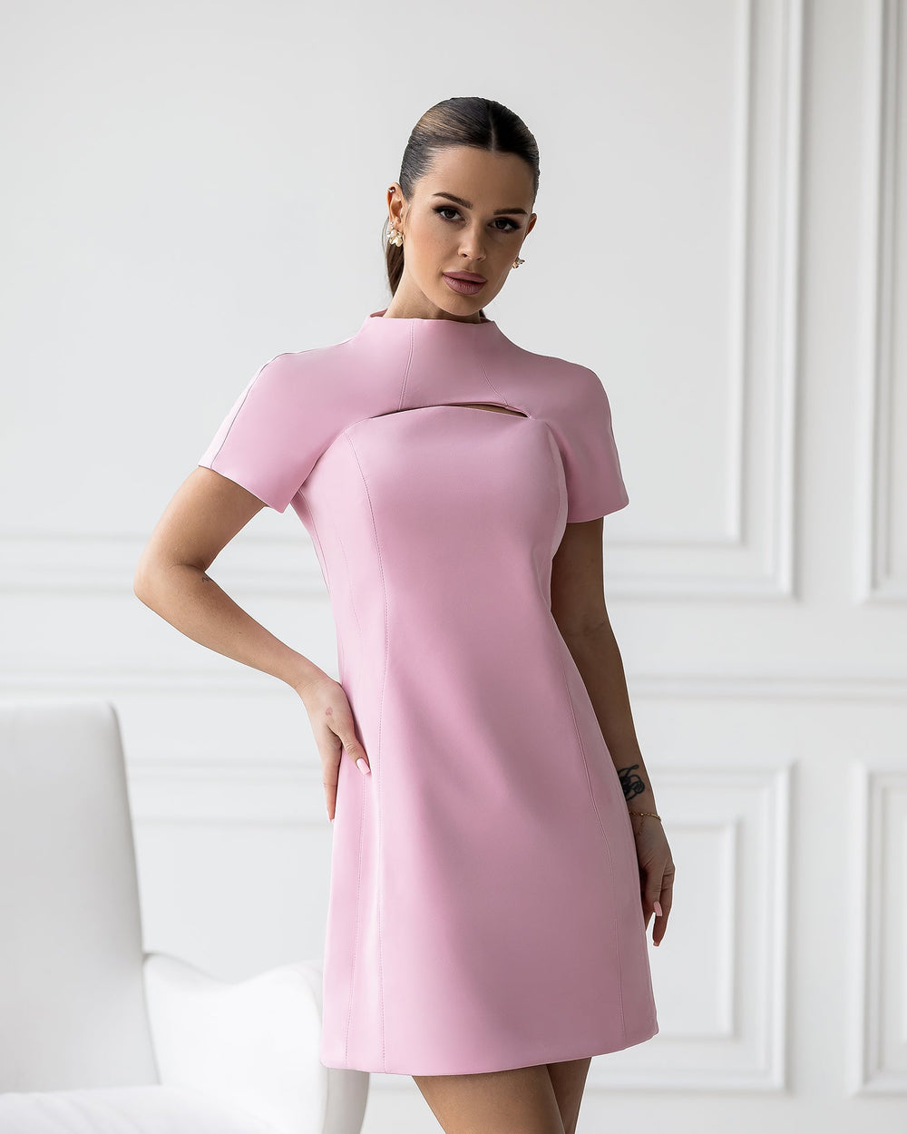 Model wearing pink Norexa dress showing cutout construction