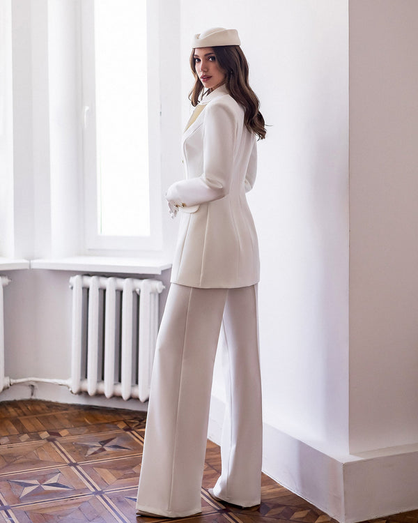 Almira Suit in white, seated position front view