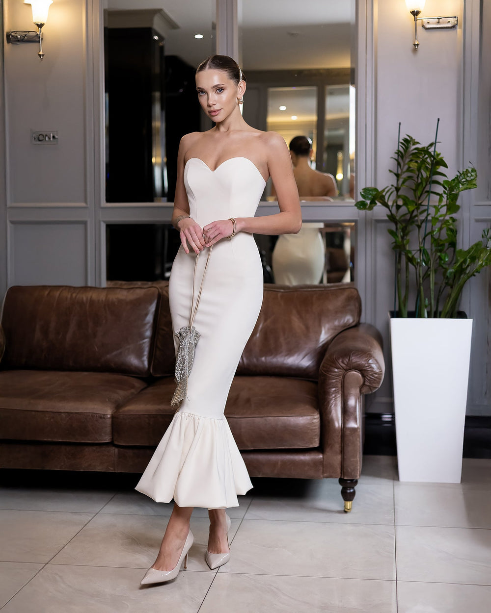Ravellia Dress in red, seated view indoors