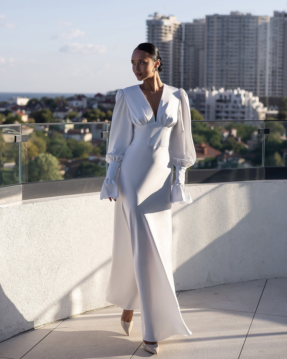 Elviana Dress in cream, cityscape view, full-body