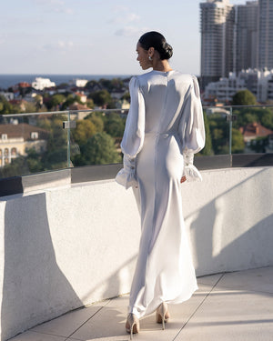Elviana Dress in white, back view, architectural setting
