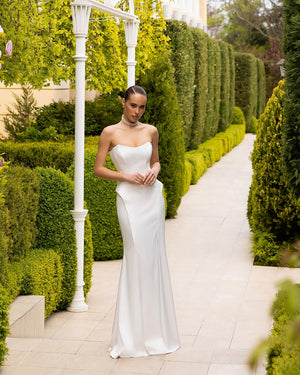 Caldoria Dress in white strapless, complete front view on balcony