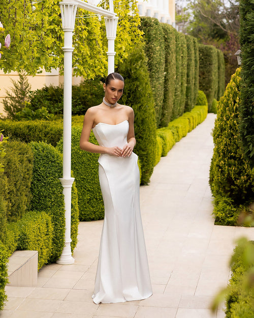 Caldoria Dress in white strapless, complete front view on balcony