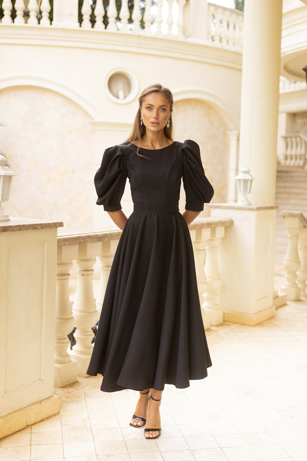 Rivana Dress in white, seated view indoors