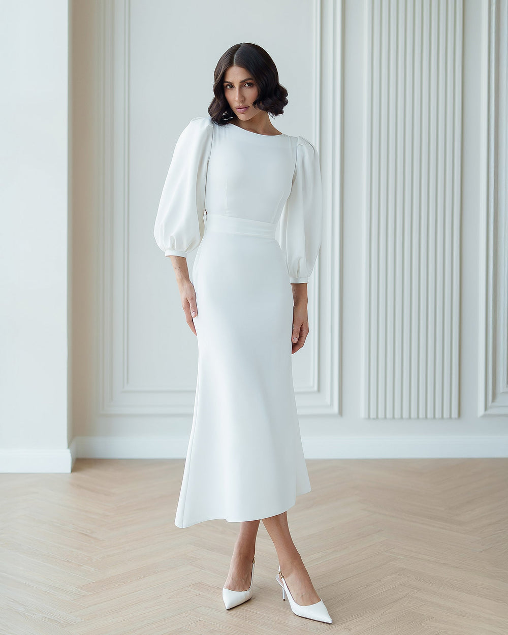 Eloise Dress in white, seated outdoor view
