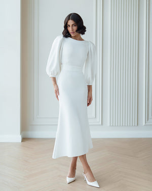 Eloise Dress in white, seated outdoor view