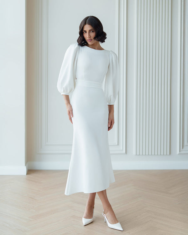 Eloise Dress in white, seated outdoor view