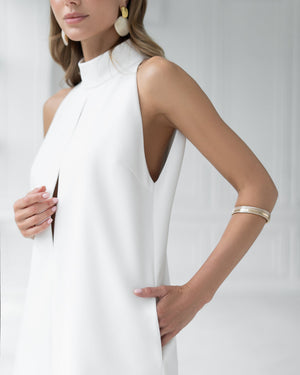 Model in white Nerina dress displaying wrapped collar feature