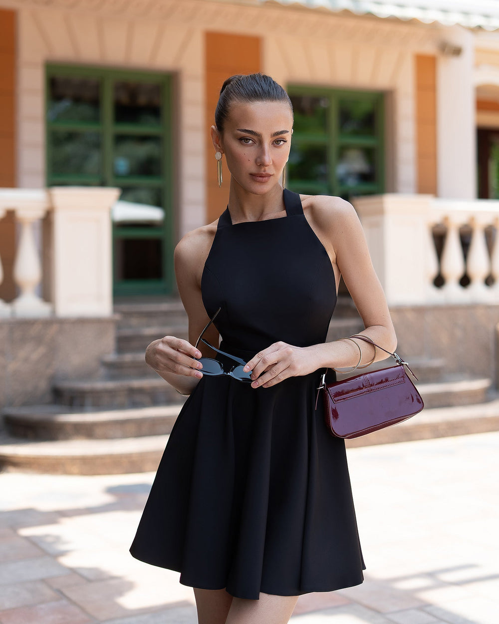 Model in black Nova halter dress showing A-line silhouette